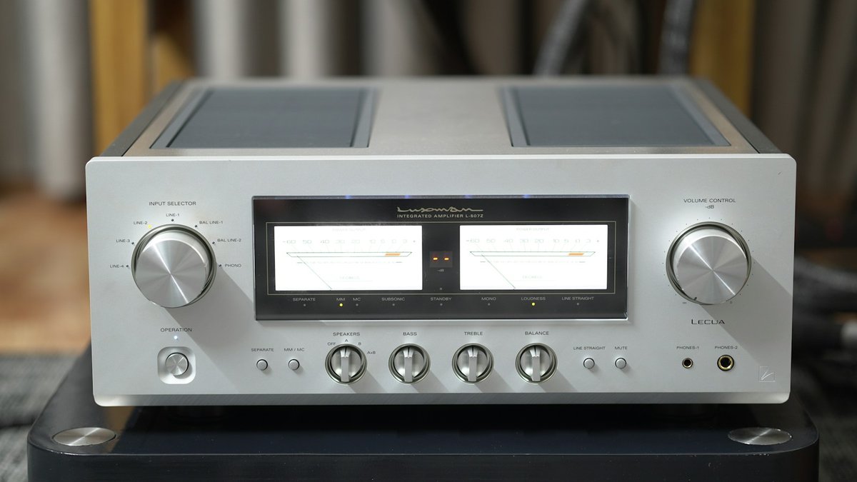 High-end audio integrated amplifier with illuminated power output meters representing reference home theater audio routing and HDMI eARC de-embedding