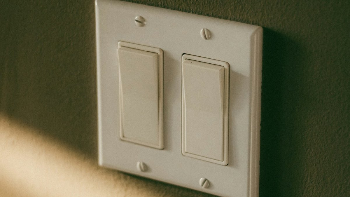 Architectural modern Decora paddle wall switch installed on interior wall representing smart home lighting control and keypad automation