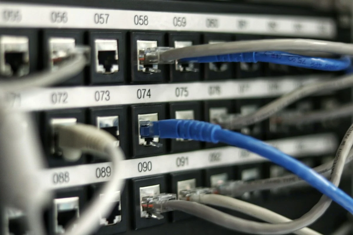 Close-up of enterprise SFP+ optical transceivers and Cat6A copper cabling plugged into 10GbE managed switch