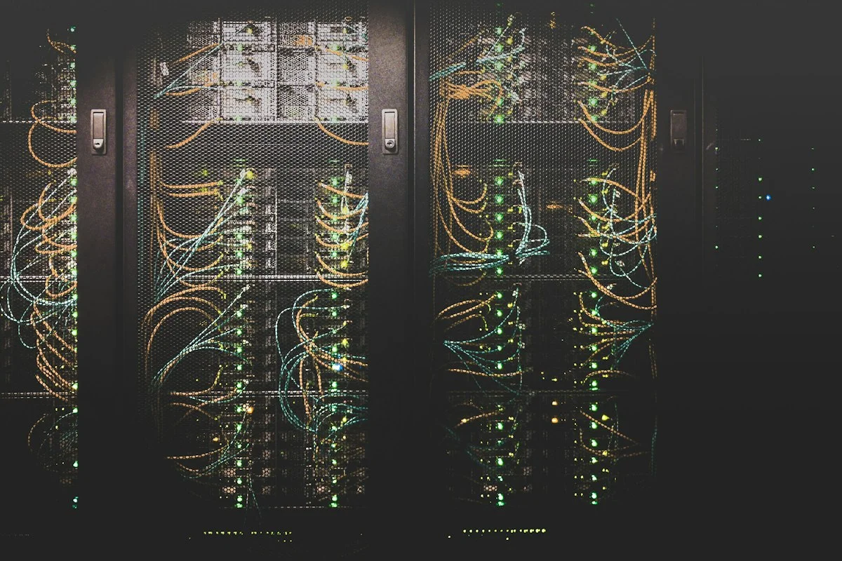 Enterprise rackmount server cluster showing storage drive bays and fiber optic transceivers in homelab